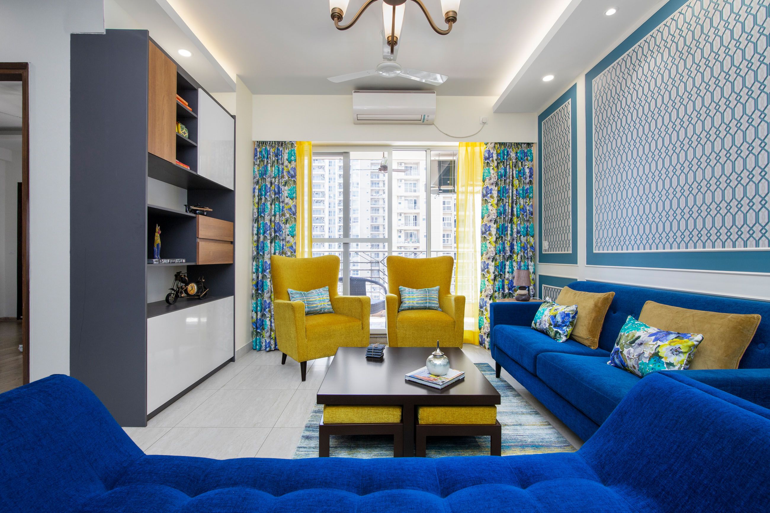 Contemporary 3-BHK Flat In Noida With Blue And Yellow Living Room Design