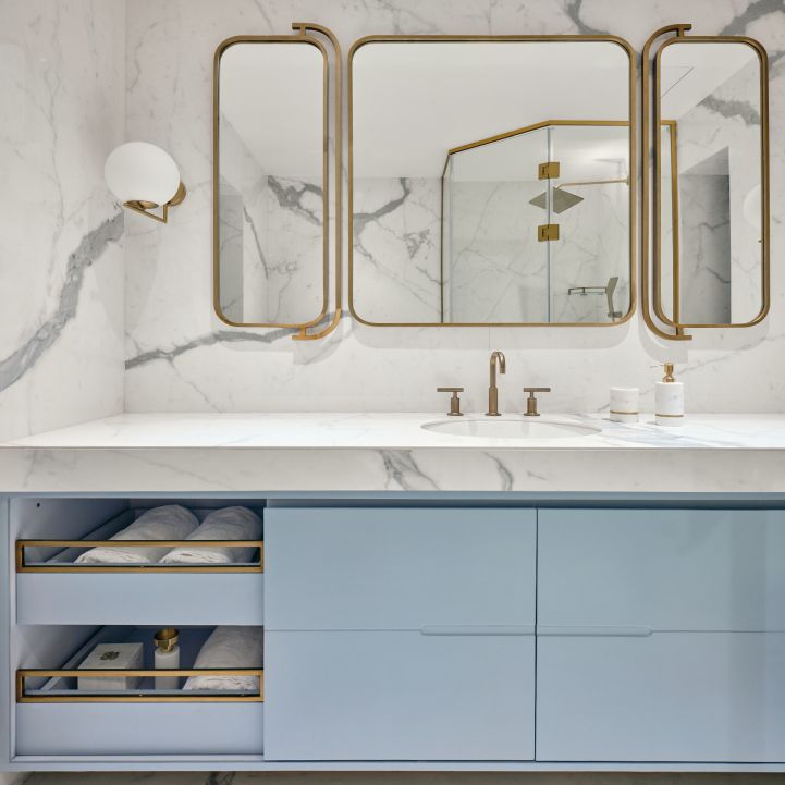 Contemporary Bathroom Design With White Marble Tiles And Blue Vanity Unit