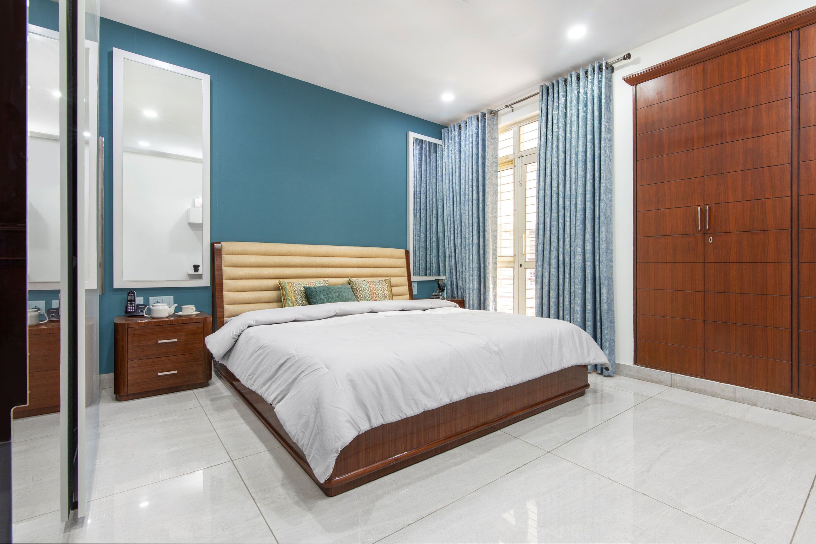 Modern Guest Bedroom Design With King-Size Bed And Blue Accent Wall